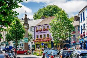 a busy street in a town with cars parked at The Greenmount in Westport