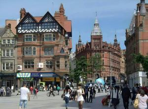 a group of people walking down a busy city street at Flat in Nottingham in Nottingham