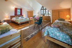 a bedroom with two beds and a table in it at Willa Alpina in Zakopane
