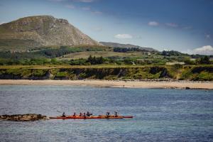 a group of people in a boat in the water at The Greenmount in Westport +3 photos