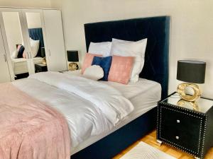 a bedroom with a large bed with pillows on it at Montreux Central Boutique Apartment Lake View and Terrace in Montreux