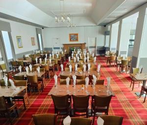 a banquet hall with tables and chairs in a room at Royal Thurso Hotel in Thurso
