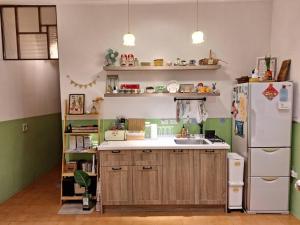 a kitchen with a refrigerator and a sink at Good Stay in Tainan