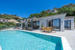 a villa with a swimming pool and a dining area at Luxury Villa Gjovana's 2 in Svoronata