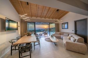 a living room with a table and a couch at Luxury Villa Gjovana's 2 in Svoronata