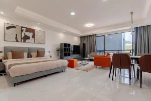 a large bedroom with a bed and a dining room at Kigali Oasis luxury Apartment No 606 in Kigali