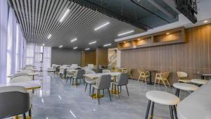 a restaurant with white tables and chairs in a room at Kigali Oasis luxury Apartment No 606 in Kigali