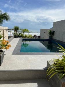 a swimming pool with the ocean in the background at Corazon De Baler in Baler