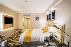 Voodi või voodid majutusasutuse Metropark Hotel Macau toas