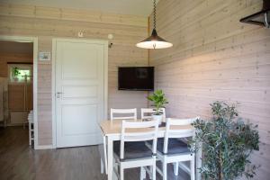 a dining room with a table and chairs and a tv at Alingsås Golfklubb in Alingsås +12 photos
