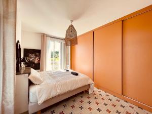 a bedroom with orange walls and a bed at L'écrin Nimois in Nîmes +19 photos