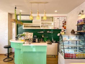 a restaurant with a green counter in a store at Inspire House Hotel in Chiang Mai