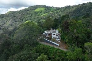 an aerial view of a house in the middle of a forest at Elettaria Valley in Devikolam