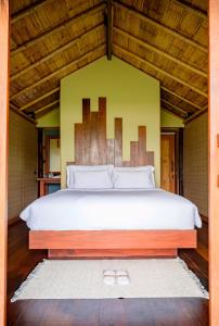 a bedroom with a large bed with a wooden headboard at Earth Elements Eco Resort in Ban Bu Hua Chang +244 photos