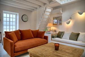 a living room with a couch and a table at Gîte le Grenier GRAY in Gray