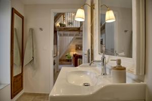 a bathroom with two sinks and a mirror at Gîte le Grenier GRAY in Gray
