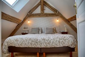 a bedroom with a large bed in the attic at Gîte le Grenier GRAY in Gray