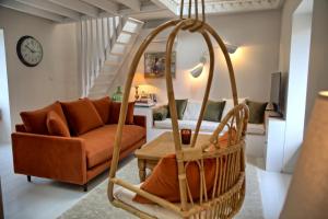 a living room with a couch and a chair at Gîte le Grenier GRAY in Gray
