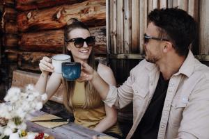 a man and woman sitting at a table drinking coffee at Hotel Dorfer in Grossarl