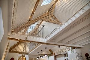 a ceiling in a building with a metal mesh at Gîte le Grenier GRAY in Gray