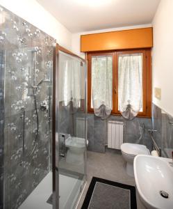 a bathroom with a shower and a toilet and a sink at Martina 2 in Marghera
