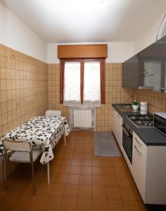 a kitchen with a table and a table and a stove at Martina 2 in Marghera