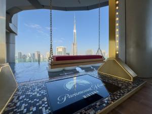 a room with a large window with a view of the city at 64th floor Skyline Pool with Burj Khalifa View in Paramount Hotel Midtown in Dubai