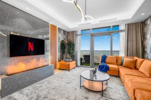 a living room with a couch and a tv at 64th floor Skyline Pool with Burj Khalifa View in Paramount Hotel Midtown in Dubai