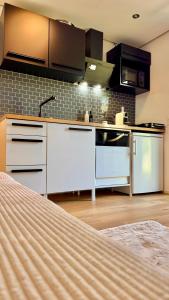a kitchen with white cabinets and a stove at Kathi´s Allgäuliebe in Weitnau