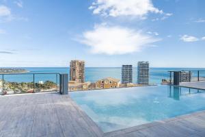 a swimming pool on top of a building with the ocean at Monaco view, pool, garage, 100 m2 terrace in Beausoleil