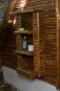 ein Holzregal in der Ecke eines Zimmers in der Unterkunft Charming Cottage in Chumani, Kilifi County in Roka
