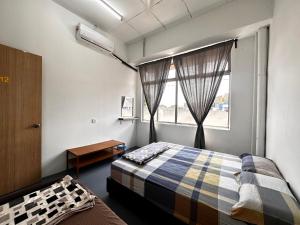 Voodi või voodid majutusasutuse Jiaxin Dormitory - Puteri Wangsa 家馨旅舍 toas