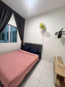a bedroom with a pink bed and a window at Lily Brava 5 in Tanah Rata