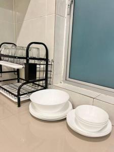 three white plates sitting on a counter in a bathroom at Lily Brava 5 in Tanah Rata +27 photos