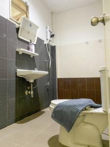 a bathroom with a toilet and a sink at Nearly City, full facilities in Chiang Mai