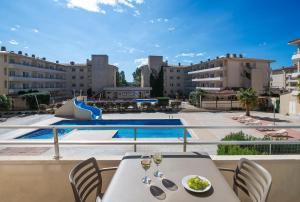 a balcony with a table and chairs and a pool at Pierre & Vacances Estartit Playa in L'Estartit