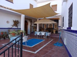 a patio with a table and an umbrella at Casa De Aventuras in Bácor