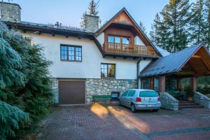 a car parked in front of a house at Willa Alpina in Zakopane