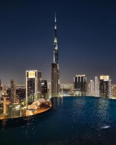 a view of a city skyline at night at 64th floor Skyline Pool with Burj Khalifa View in Paramount Hotel Midtown in Dubai
