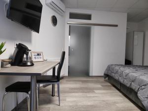 a room with a table and a bed and a bedroom at Offbase Lodging No6 in Ramstein-Miesenbach