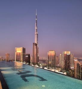 a swimming pool on top of a city skyline at 64th floor Skyline Pool with Burj Khalifa View in Paramount Hotel Midtown in Dubai