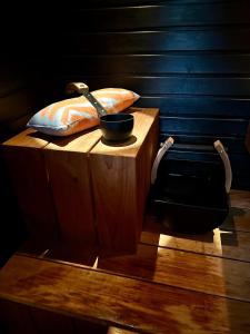 a wooden stand with a bowl and a wand on it at ReindeerCabin PoroMökki LEVI in Kittilä