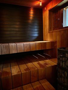 an empty sauna with wooden walls and wooden floors at ReindeerCabin PoroMökki LEVI in Kittilä +12 photos