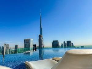 a swimming pool with a view of the burj khalifa at 64th floor Skyline Pool with Burj Khalifa View in Paramount Hotel Midtown in Dubai