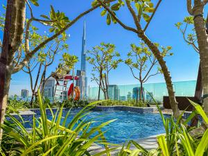 a swimming pool with a view of the burj khalifa from the city at 64th floor Skyline Pool with Burj Khalifa View in Paramount Hotel Midtown in Dubai