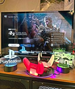 a tv with a display of shoes on a table at Jonker Street New Cozy Home 20pax Swimming Pool Karaoke in Melaka