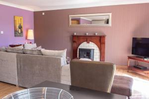a living room with a couch and a fireplace at Wild Oats Lodge 6, Yellowtop Country Park in York