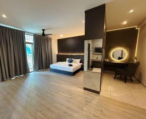 a bedroom with a bed and a desk and a mirror at 3 Story House With Jacuzzi PlyGround 18Pax Melaka Town 10min Jonker in Tranquerah +66 photos