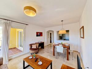 a living room with a table and a dining room at Riviera Relax & Pool in Mijas Costa