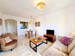 a living room with a couch and a table at Riviera Relax & Pool in Mijas Costa
